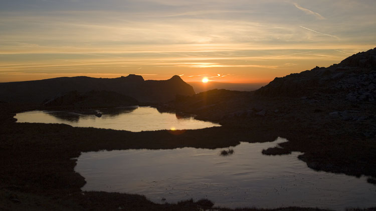 Sunrise over Pike of Stickle and frozen Lincombe Tarns Sunrise over Pike of Stickle and frozen Lincombe Tarns